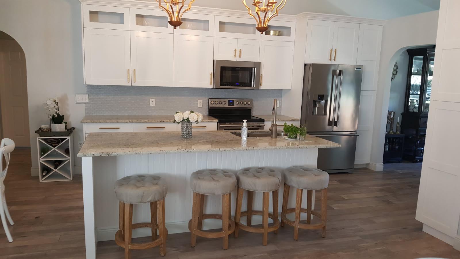 Custom kitchen remodel with white shaker cabinets, granite island, and hardwood floors — Ultimate Design Remodelling LLC, Pasco County FL