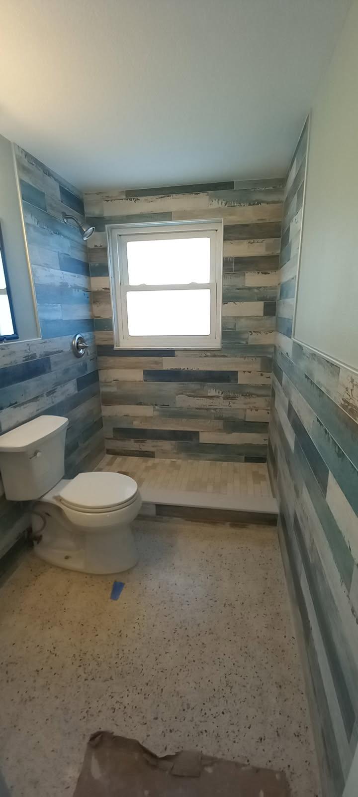 Bathroom renovation with coastal wood-look tile walls — bathroom remodelling contractor Pasco County FL